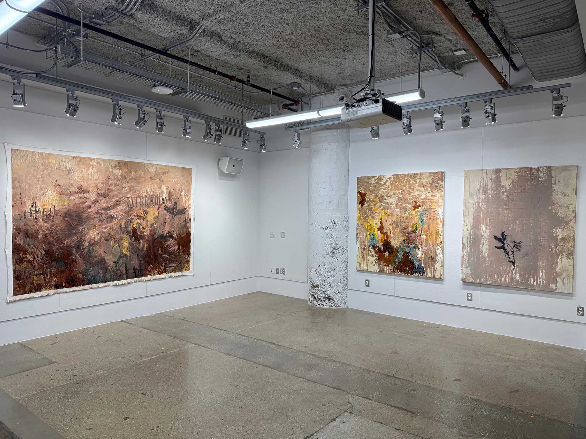 Contemporary art gallery with three abstract paintings. Neutral tones, textured surfaces, and an industrial vibe with exposed ceiling elements.